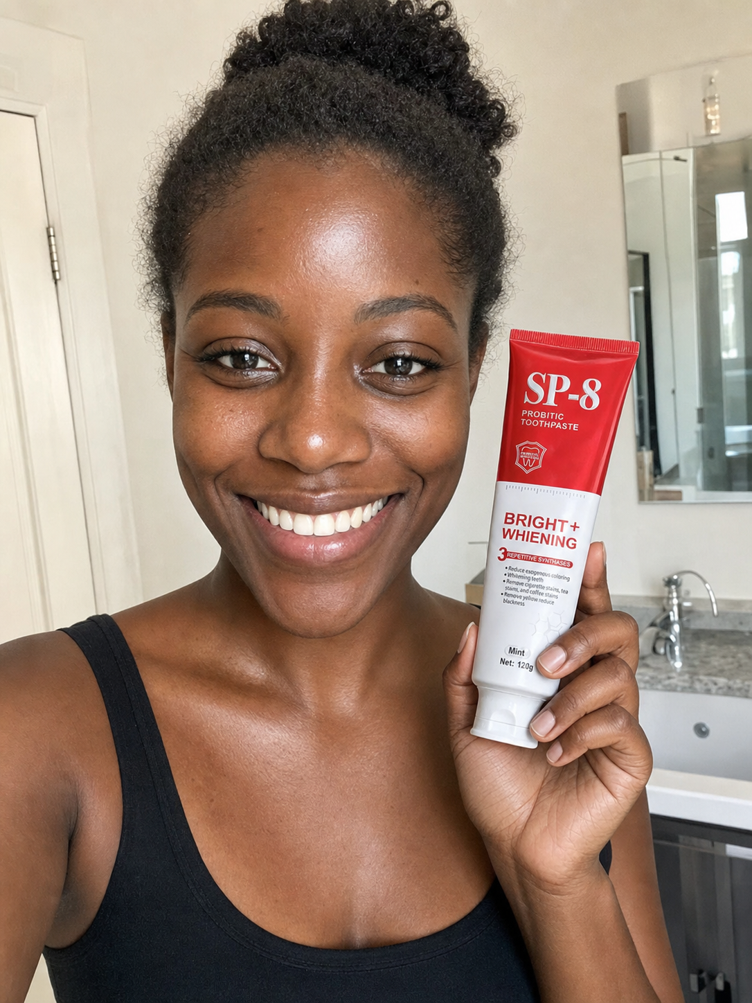Teaching-demo customer photo of a smiling Black woman holding SP-8 toothpaste