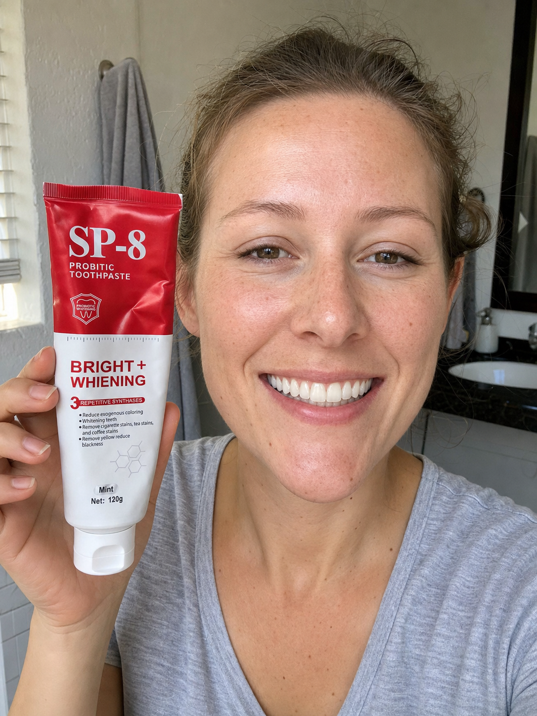 Teaching-demo customer photo of a smiling white woman holding SP-8 toothpaste